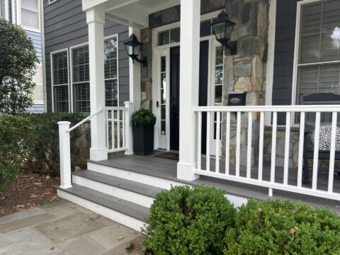 Renovated front porch in Arlington VA with new stairs, white railing and PVC-wrapped posts
