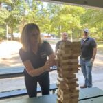 Core Outdoor Living team members play giant Jenga during a company picnic at Burke Lake Park.