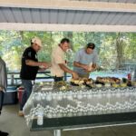 Core Outdoor Living crew gathers around the lunch buffet during a team picnic in Northern Virginia.